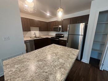 A kitchen featuring a stainless steel refrigerator.